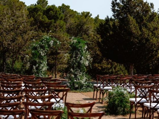 Chairs arranged for a wedding ceremony in a natural setting.