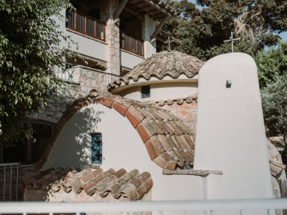 Charming church nestled among greenery and stone architecture.