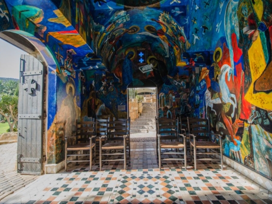 Vibrant painted walls in an artistic chapel space.