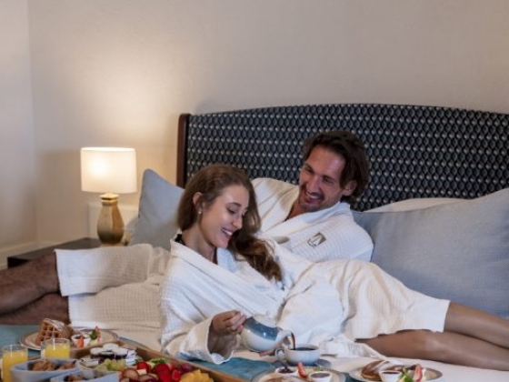 Romantic breakfast scene in a hotel room.
