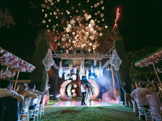 A magical wedding scene with fireworks and floral decorations.