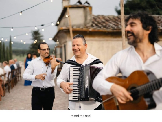 Joyful musicians serenade guests at a beautiful outdoor celebration.