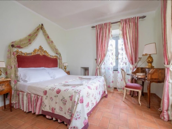 Charming room featuring ornate furniture and floral patterns.