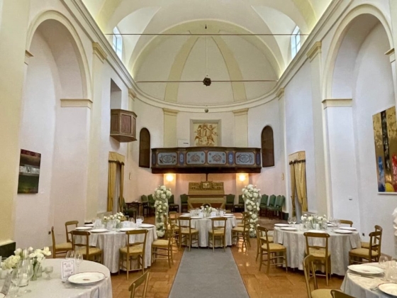 A charming venue featuring tables and floral arrangements.