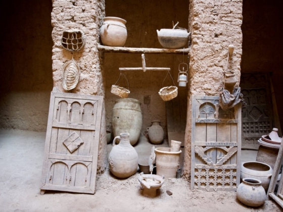 Display of historical pottery and wooden artifacts.