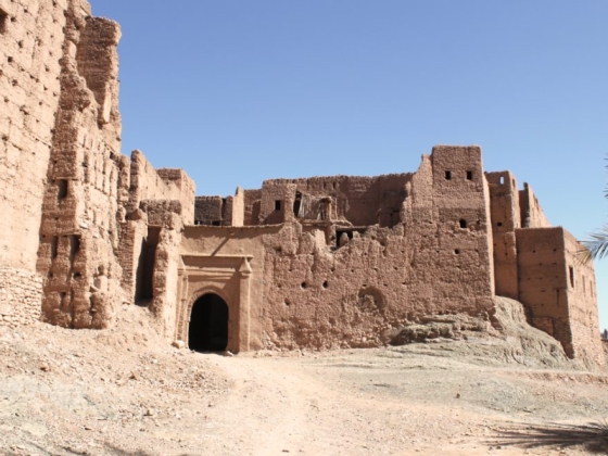 Historic earthen structures against a blue sky.