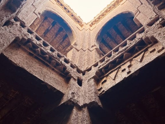 Looking up at a historic building's interior with a bright skylight