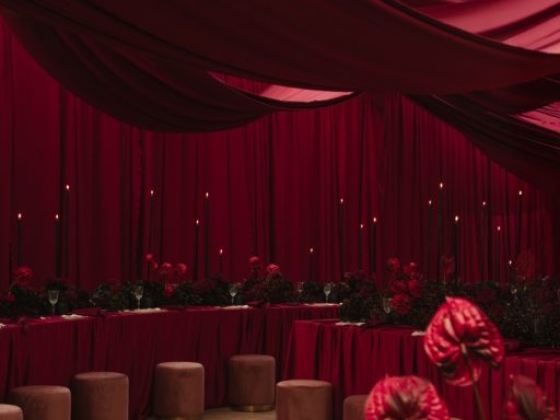 A beautifully arranged space with red drapery and floral accents.