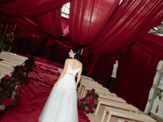 A bride approaches the altar in a beautifully decorated venue.