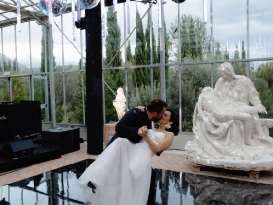 Bride and groom share a kiss on the dance floor.