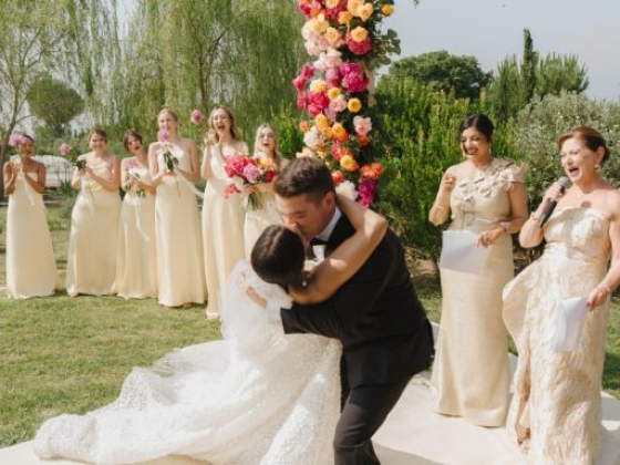 Joyful moment at a wedding ceremony with guests in attendance.