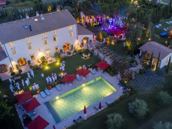 Guests enjoy a festive evening by the illuminated pool area.