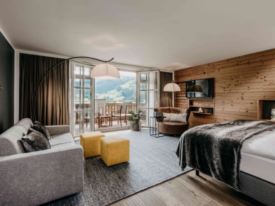 Stylish room featuring a balcony and comfortable furnishings.