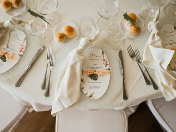 A beautifully arranged table with menu cards and bread rolls.