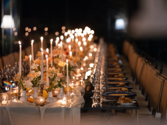 A beautifully arranged dinner table with soft lighting.