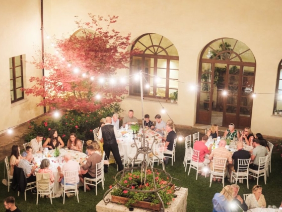 A festive gathering at night with dining tables and decor.