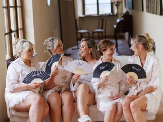 Bridesmaids enjoying a lighthearted moment together.