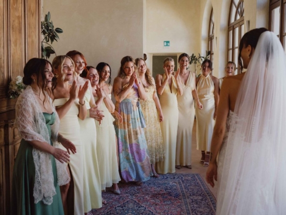 Joyful moment of bridesmaids greeting the bride