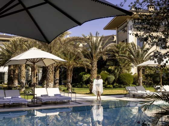 Scenic poolside view with a woman in a resort setting.