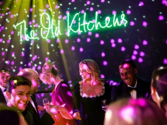 Guests enjoying a lively party atmosphere at The Old Kitchens