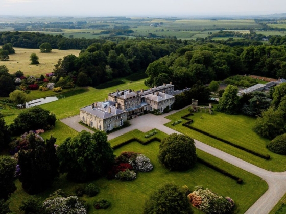 Expansive estate with landscaped gardens and scenic fields.