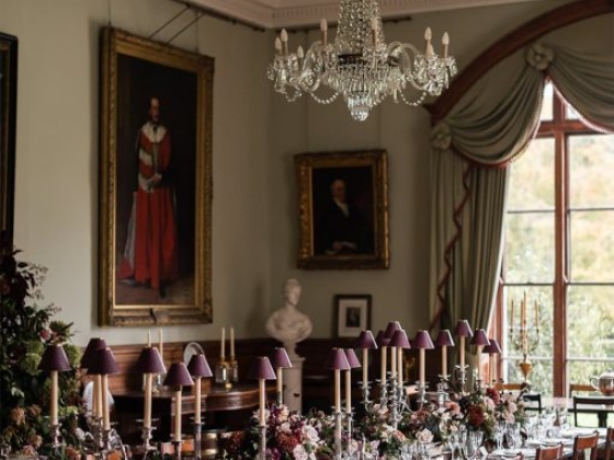 A beautifully set table in an ornate room.