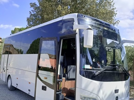 A spacious bus with open doors ready for passengers.
