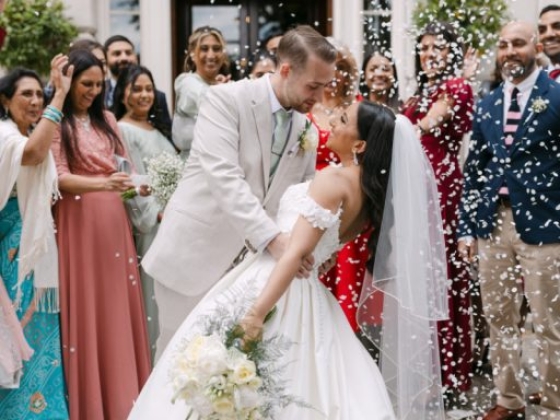 A joyful wedding moment with confetti and happy guests.