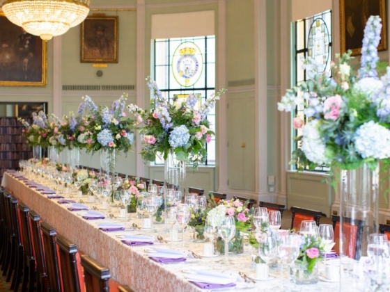A beautifully arranged dining table with floral centerpieces.