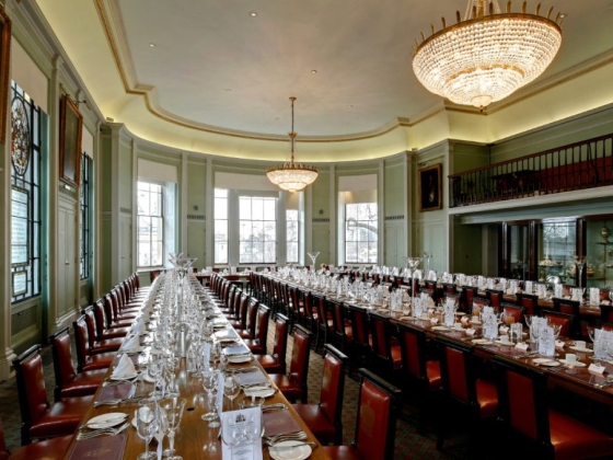 Spacious room featuring a grand table and chandelier