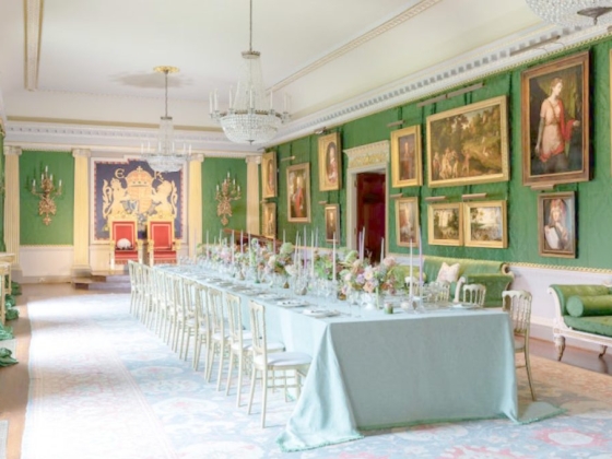 Luxurious banquet hall featuring a long table and art-filled walls.