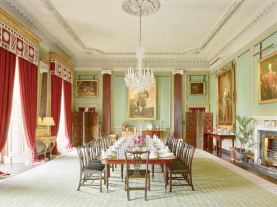 Spacious dining room featuring a long table and rich decor.