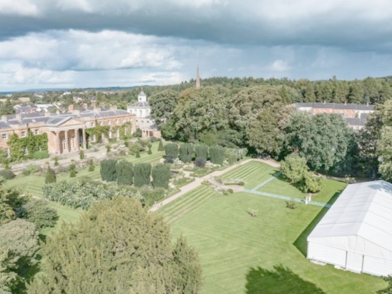 Beautiful garden with a grand old building and a marquee tent