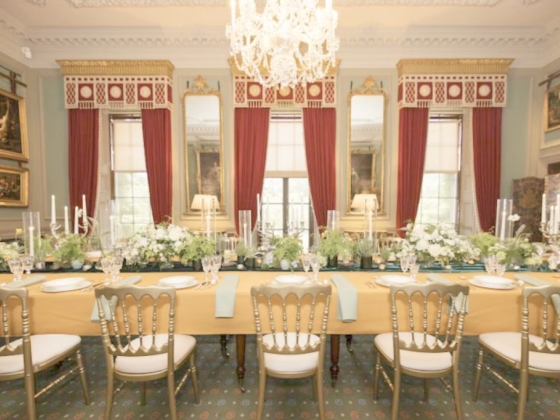 A beautifully arranged dining table in an ornate room.