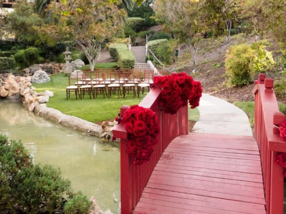 Scenic view of a garden wedding setup by a pond.