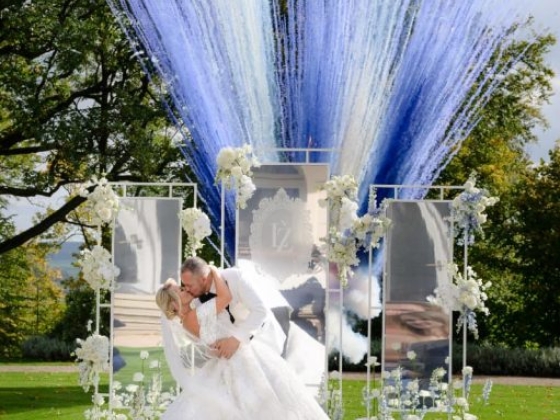 A romantic wedding kiss with vivid decorations.