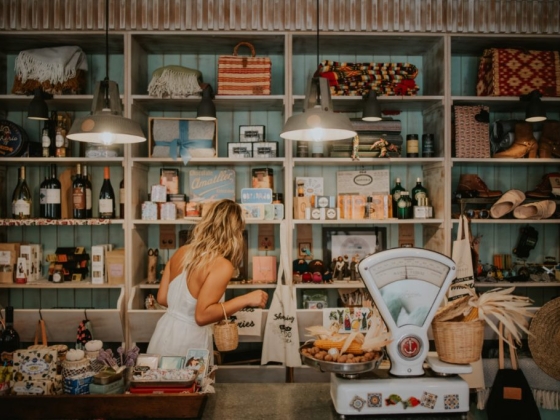 A woman explores various goods in a quaint shop.