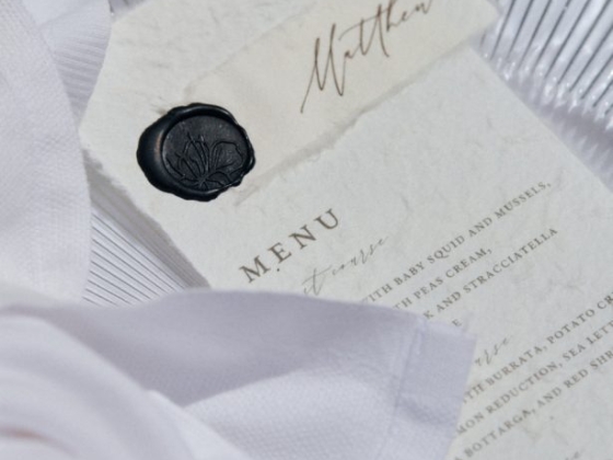 Artistic presentation of a menu and napkin arrangement.