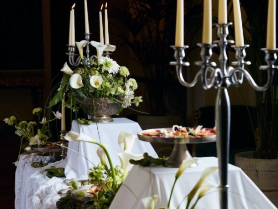 A beautifully arranged table with candles and flowers.