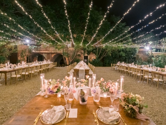 Beautifully arranged tables under starry lights.