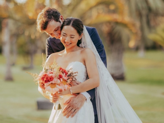 Joyful moment shared by newlyweds in a beautiful garden