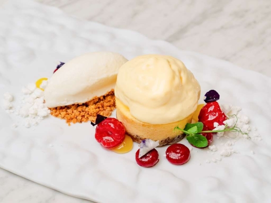 A beautifully plated dessert featuring ice cream and fresh berries.
