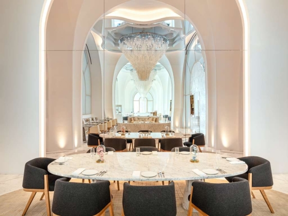 Stylish restaurant interior showcasing a large table and decor.