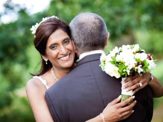 A joyful moment between a bride and her partner outdoors.