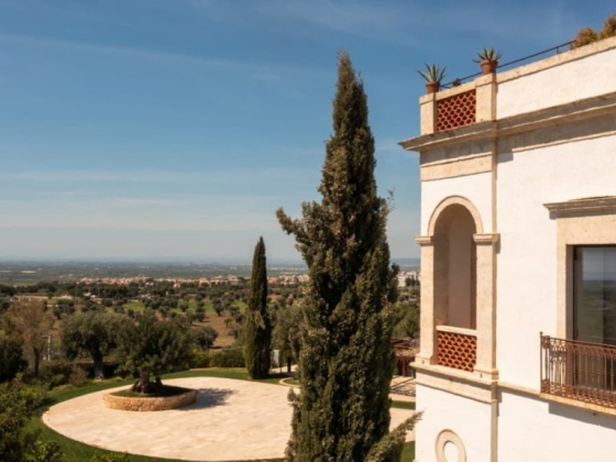 A charming villa with scenic landscape in the background.