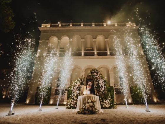 A romantic wedding scene with fireworks and floral decor.