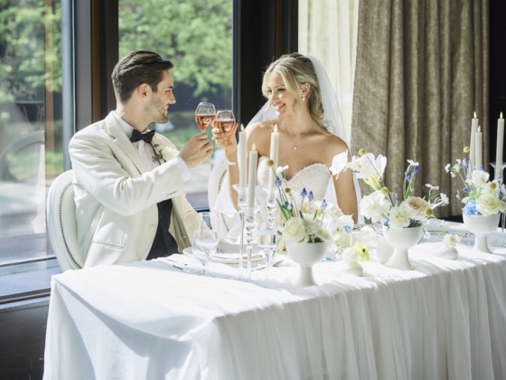 A joyful wedding toast by a couple at their reception.