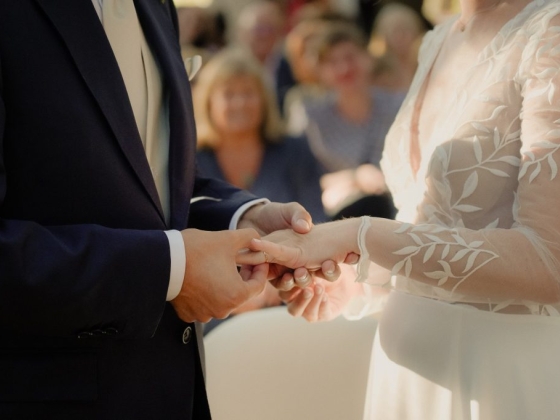 A bride and groom share a moment at their wedding.