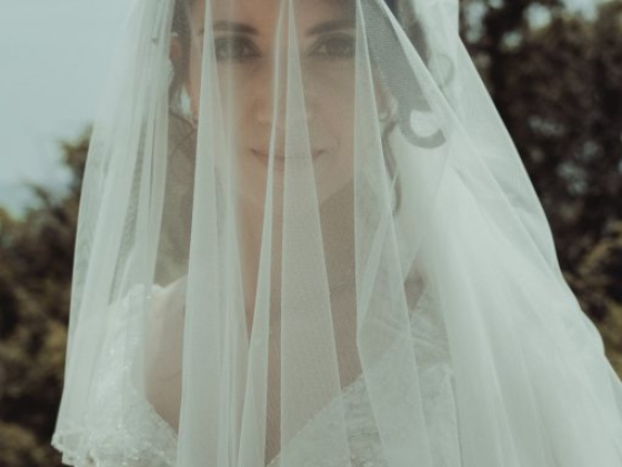 A bride gazes softly, adorned in a beautiful wedding dress.