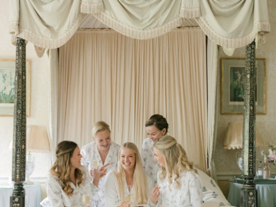 Friends enjoying a fun gathering in a cozy bedroom.